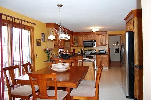 Kitchen & dining area adjoin the family rm, forming a spacious, open area