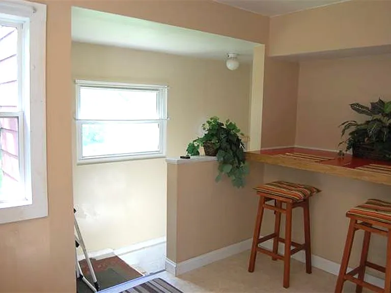 Back door entry up a few steps into kitchen or down steps to basement