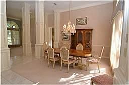 Dining room enhanced by raised ceilings, double crown molding, chair rails and a beautiful chandelie