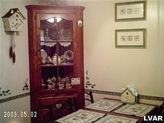 In the center of the home , put a table, notice the built in corner cabinet