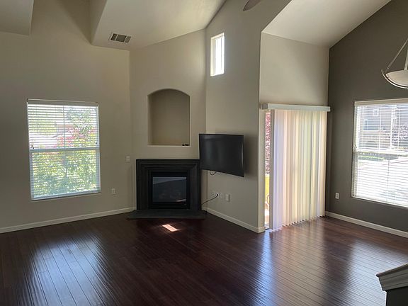 Living area with gas fireplace. 55" curved TV included