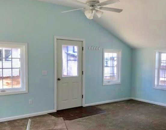 Living area with high ceilings and ceiling fan