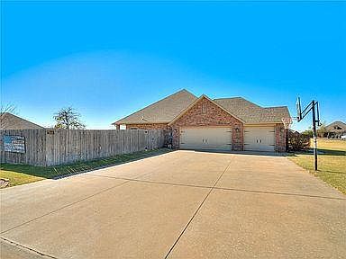 Oversized 3 car garage with dedicated space for a freezer or refrigerator. In ground basketball hoop!