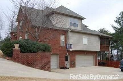 View of driveway- 3 car garage
						:
						Garage has separate storage area and lots of built-in wood shelving