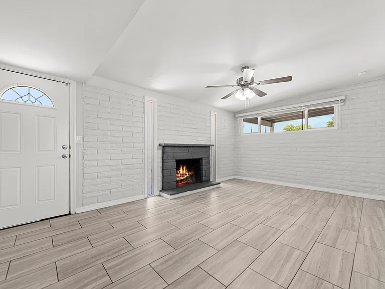 Spacious living room with a warm fireplace, ideal for gathering with family and friends.
