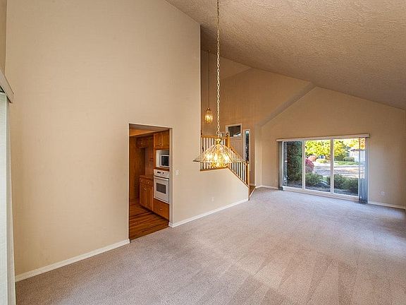 Living room/dining room with floor-to-ceiling windows