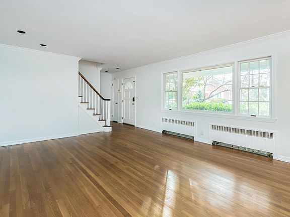 Living room looking at front yard and staircase to second level