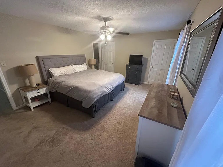 Expansive master bedroom with three walk-in closets, abundant storage space, and a beautifully remodeled private en-suite bathroom.