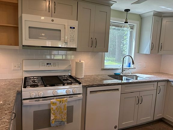 The completely updated kitchen includes 2 granite peninsula's, roll out cabinetry, new appliances and undercabinet lighting.
