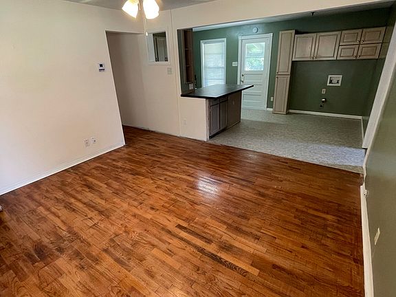 Living room is the first room you walk into from front door. Looking into dining room and kitchen.