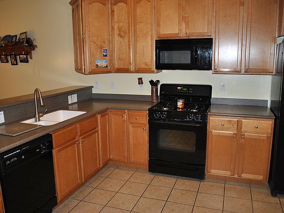 kitchen tile has been removed and replaced with wood laminat