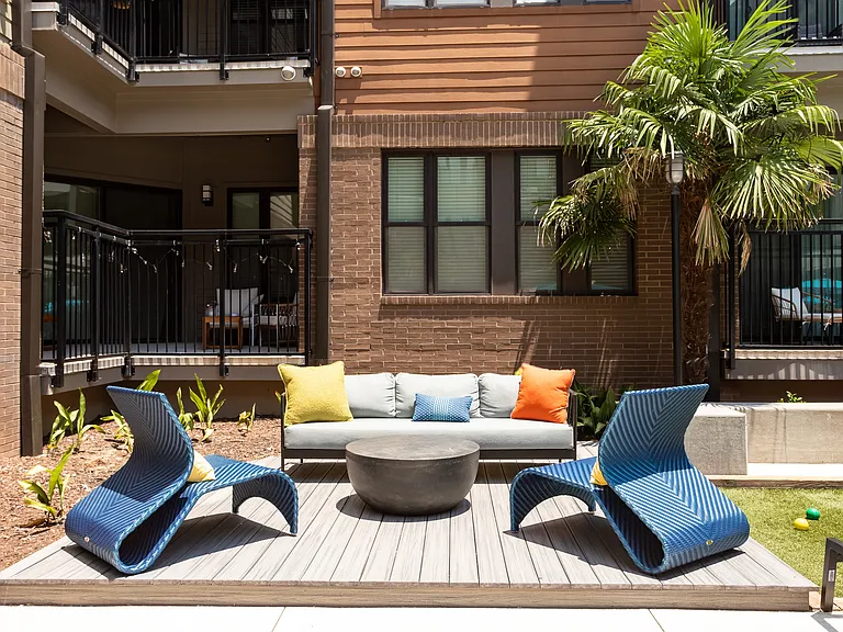 Cozy Courtyard Gathering Spot with Stylish Chairs and Coffee Table