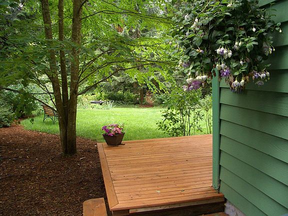The large lower deck ties the house to your 'clearing in the forest'.