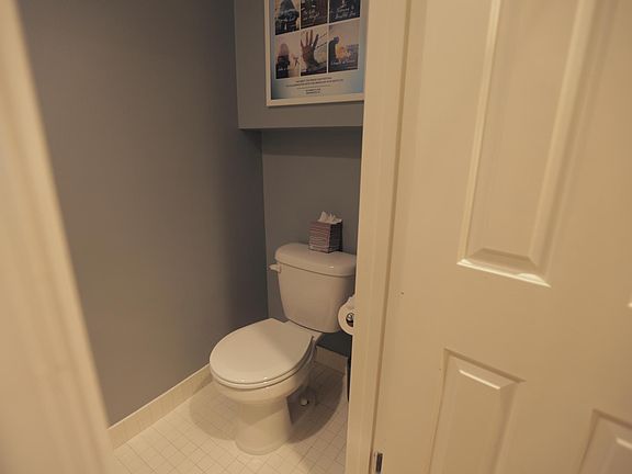 Powder room bath inside front door, adjacent the coat closet