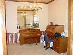 Formal dining room with art niche, chandelier lighting and neutral carpet