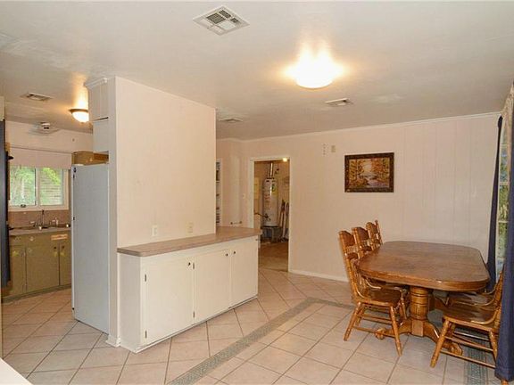 Large Breakfast area looking int Kitchen and Laundry room.