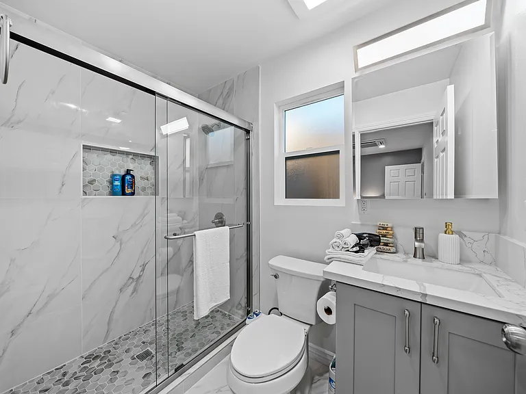 Clean and modern bathroom with fresh towels and essentials provided.