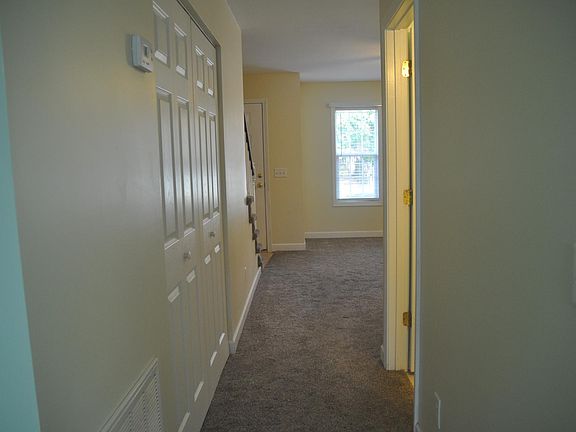 View of living room from kitchen showing Laundry closet on l