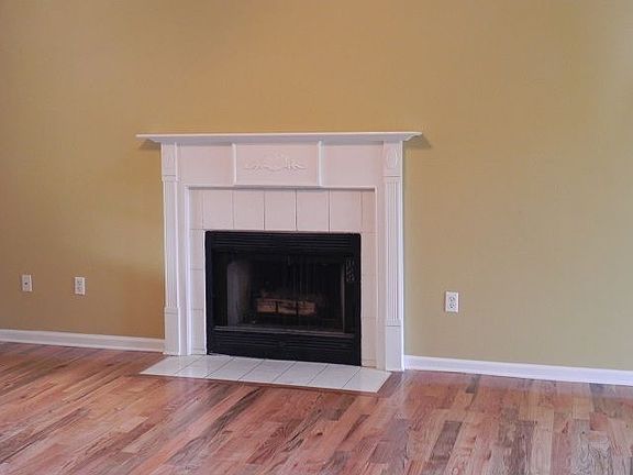 Den with woodburning fireplace