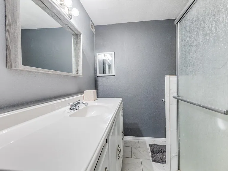 Bathroom vanity with an integrated sink and chrome faucet