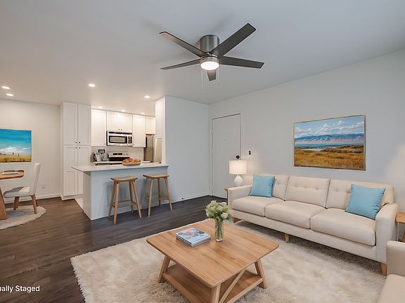 Open floor plan from living room to kitchen (virtually staged)