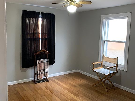 Main bedroom without furnishings looks over back garden