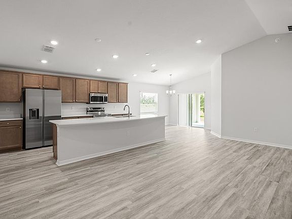 This sunny, open layout home features volume ceilings and low-maintenance LVP flooring.