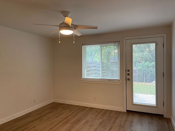 Bedroom 1 with door to back yard and walk in closet.