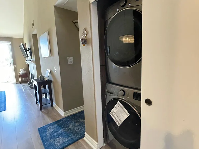 Laundry room with new quite washer and dryer. You will find laundry detergent and cleaning supplies in this closet too.