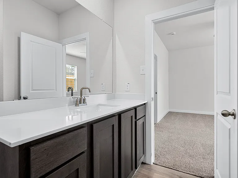 The master bathroom has a sprawling vanity.