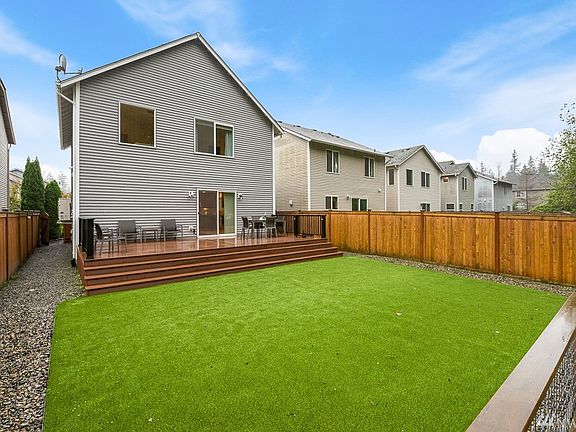Park-like backyard with Easy maintenance turf lawn and Trex deck!