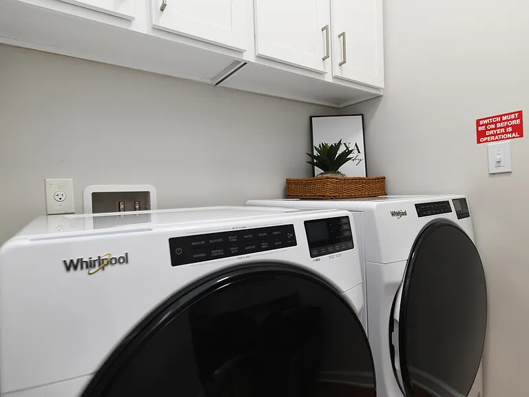 Laundry room with built in shelving and storage