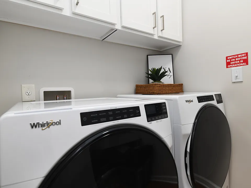Laundry room with built in shelving and storage