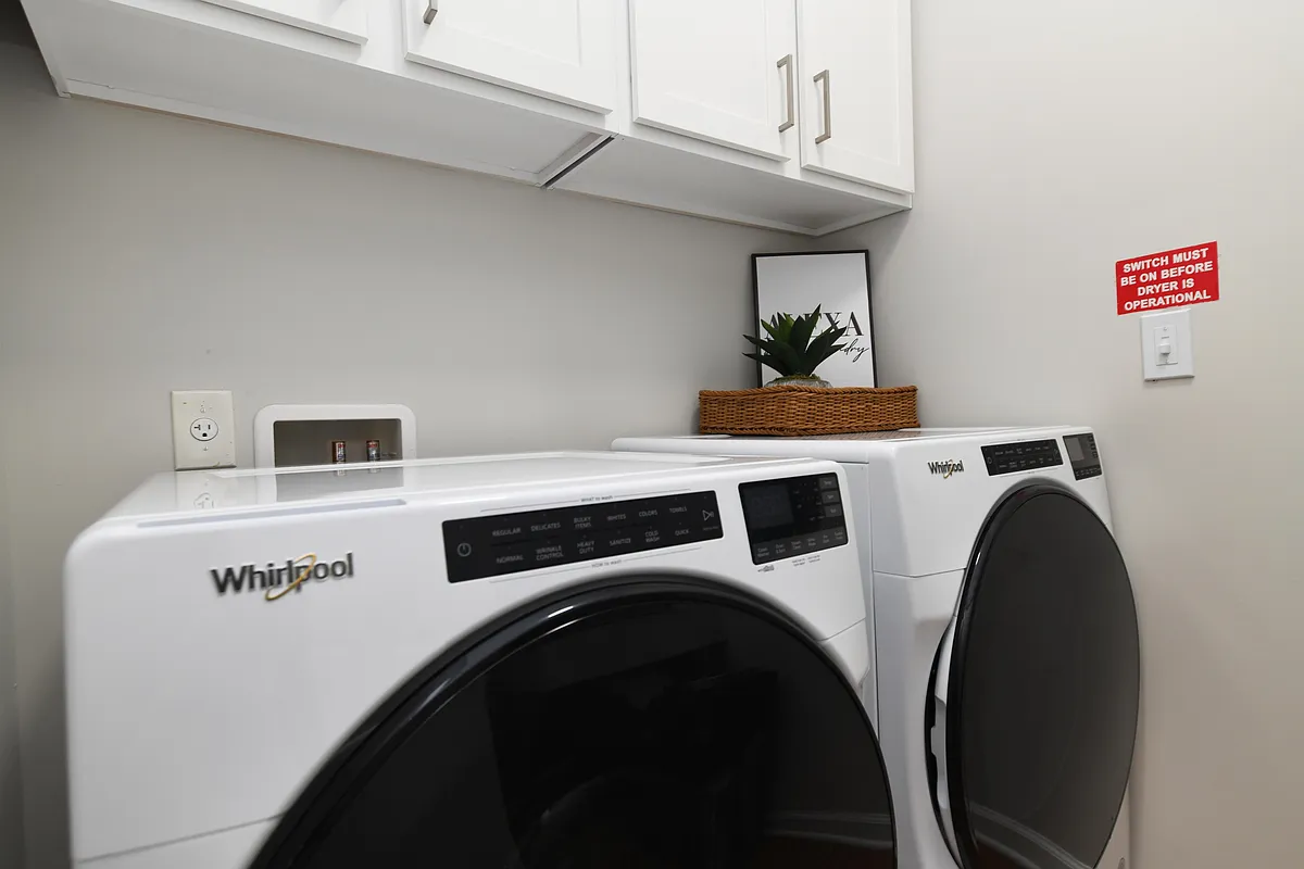Laundry room with built in shelving and storage - The Palmer