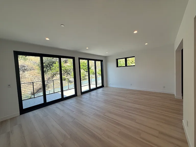 Massive living room with 2 sliders that go to a large, private balcony