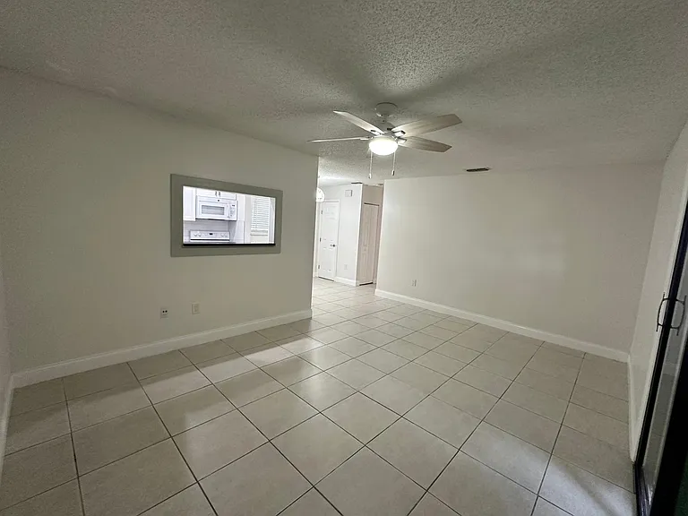 LIVING ROOM. 
VIEW FROM FRONT DOOR LOOKING INTO KITCHEN/NOOK AREA.