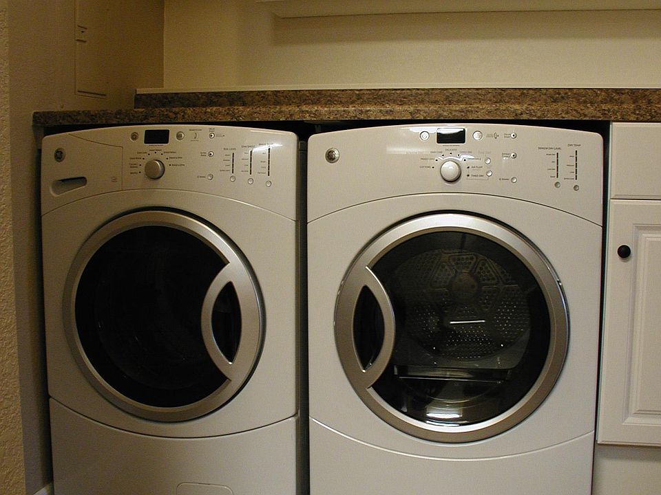 Full size high efficiency washer and dryer with many options, side cabinet the perfect height to store laundry and cleaning supplies, plus pantry cabinet above. Laminate melamine counter great for laundry tasks, and includes an attached power strip for ir