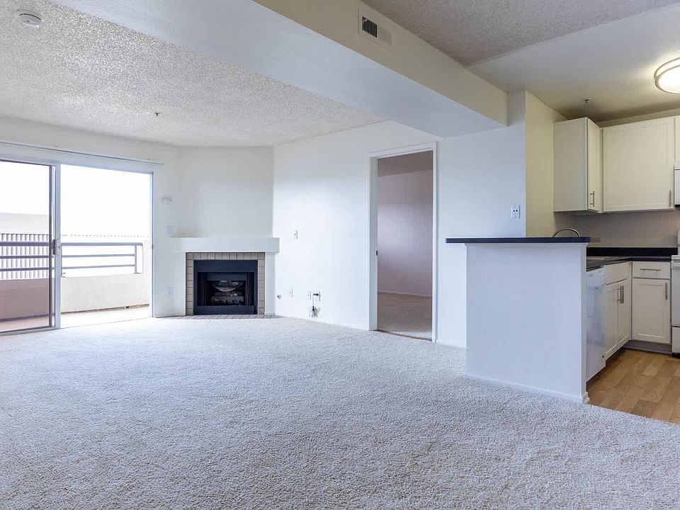 Carpeted Living Room with Fireplace and Balcony