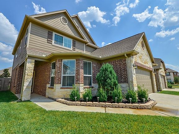 The covered porch and bay window create an inviting entry to this lovely home.