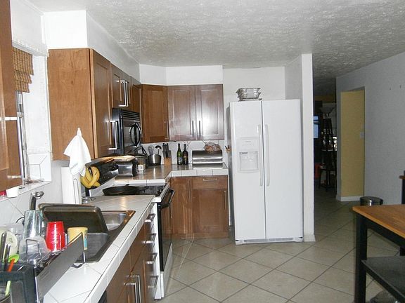 Kitchen is bright and sunny. Easy care tile flooring and newer cabinetry.