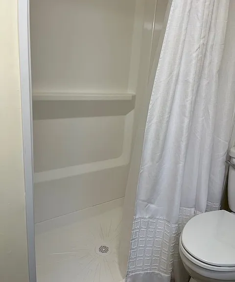 Bathroom has stand up shower.