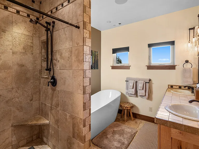 Master bath is Montana Travertine and has luxurious six showerheads.