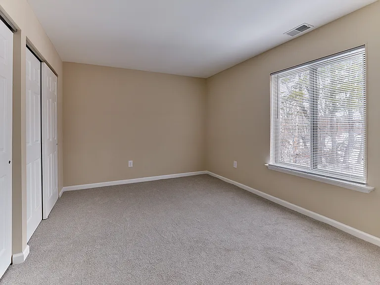 Bright secondary bedroom with large window and ample closet space in this 2 bedroom, 2 bathroom apartment at North Crossing in Willow Grove, PA.