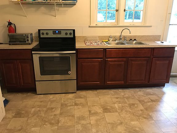 New cabinets installed in 2020 with new full size electric range with cooktop. Plenty of cabinet space for dishes/small appliances, trash cans and more. Natural sunlight comes in over the sink and windows overlook the yard.