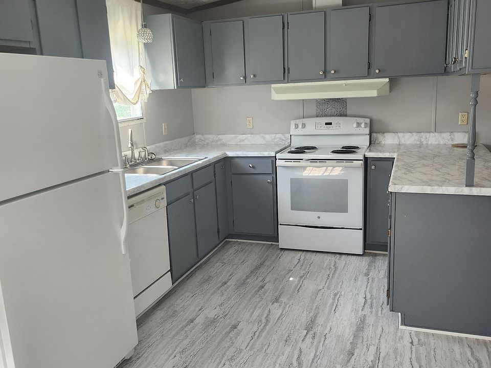 Kitchen with stove, refrigerator and dishwasher.