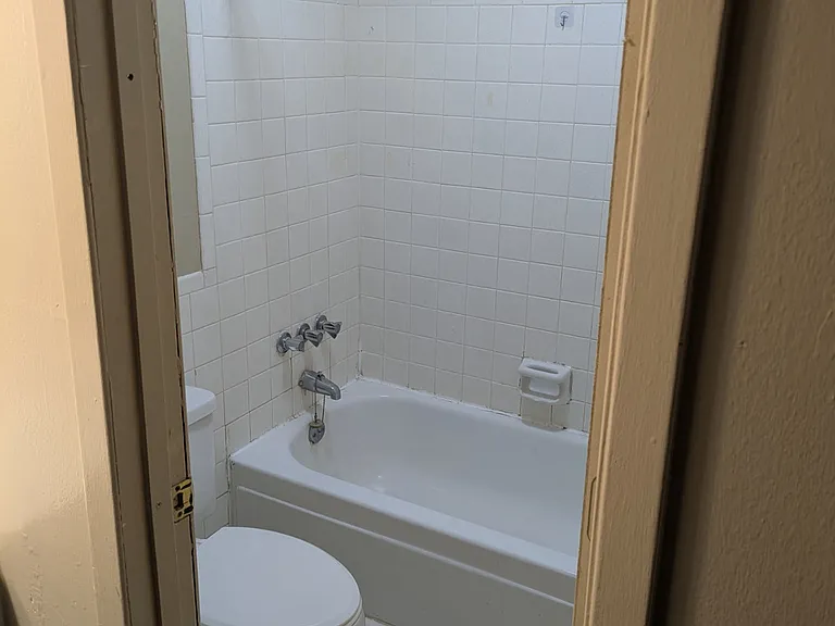 Bathroom contains commode and bathtub.
