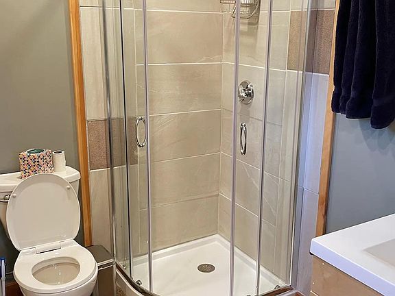 Tiled shower with glass enclosure