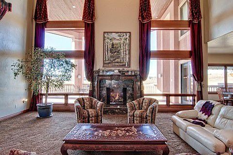 Great room w/floor-to-ceiling windows & granite surround fp