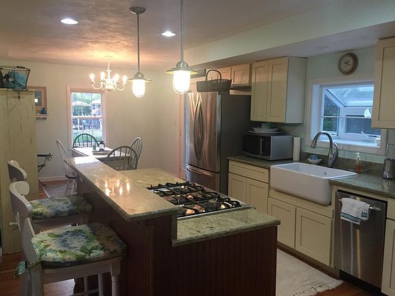 Modern kitchen with breakfast bar and dining room.