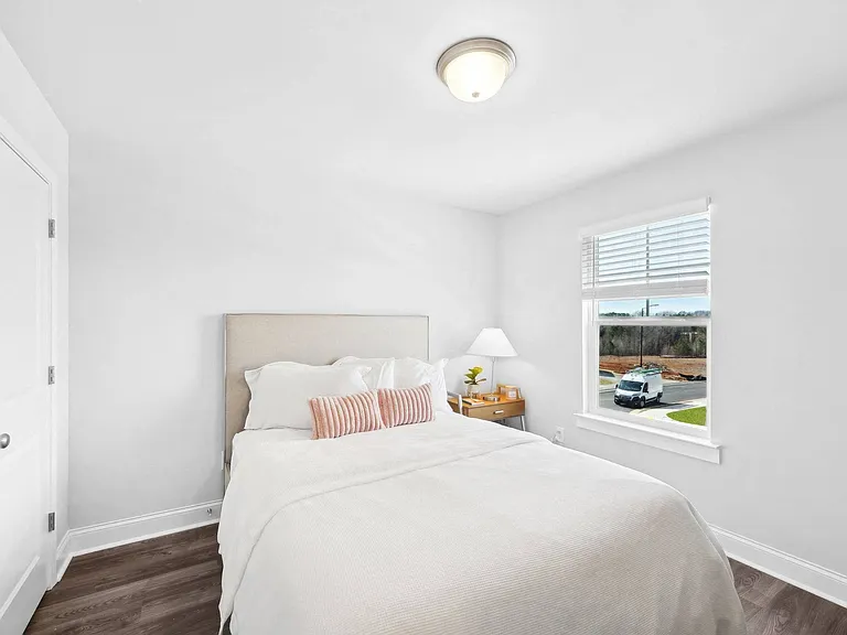 Bright and airy secondary bedroom with a queen bed.